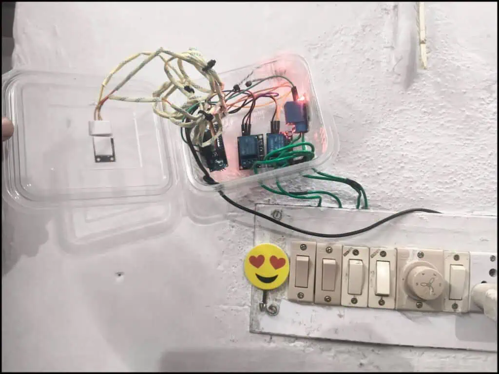 Real Arduino Nano relay control setup mounted on wall for fan and light automation using IR remote.