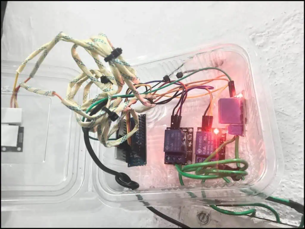 Arduino Nano connected with relay modules and IR receiver inside plastic box for home automation.