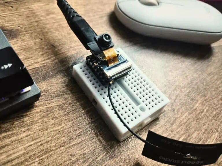 XIAO ESP32S3 Sense camera module wired on a breadboard with WiFi antenna